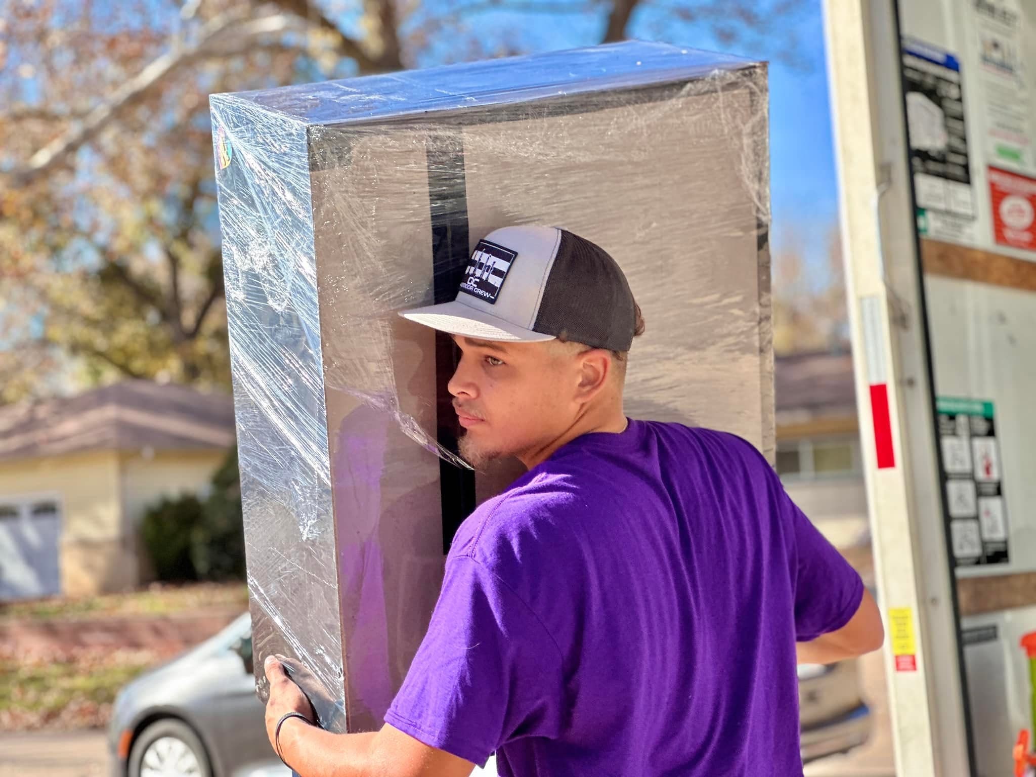Jam'N Moving crew loading a customer's belongings into the truck